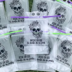 there are many bags that have skulls on them and purple straws in each bag