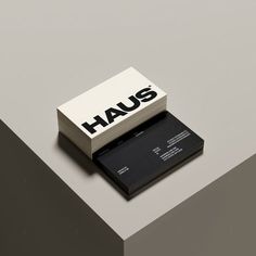 a black and white business card holder with the word haus printed on it's front