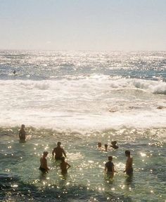 many people are in the water at the beach