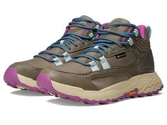 a pair of hiking shoes with purple and blue laces on the outstep