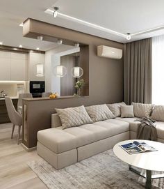 a living room filled with furniture next to a kitchen