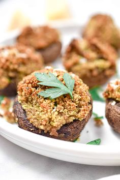 stuffed mushrooms with herbs and seasoning on a white plate, ready to be eaten