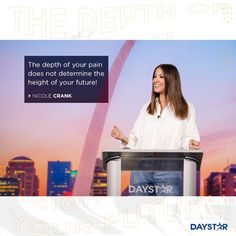 a woman standing at a podium giving a speech with the st louis arch in the background