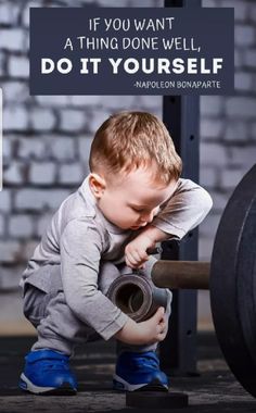 a little boy is playing with a barbell in front of a sign that says if you want a thing done well, do it yourself