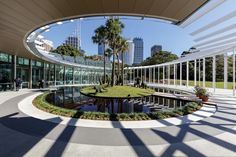 a circular building with palm trees in the center