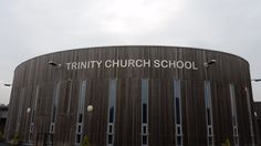 a large building with a sign that says trinity church school