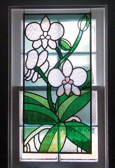 a stained glass window with flowers on it