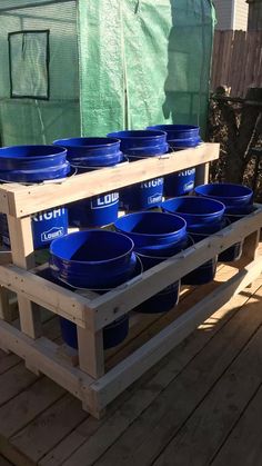 several blue bowls are stacked up on a pallet