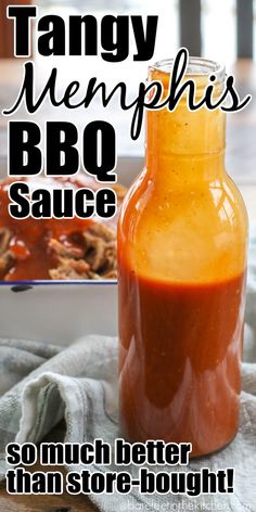 a bottle filled with bbq sauce sitting on top of a table next to a plate of food