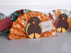 three paper turkeys with name tags on them