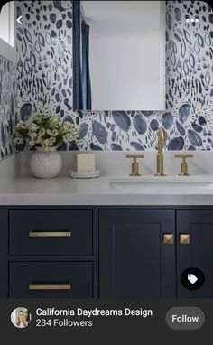 a bathroom vanity with blue and white wallpaper