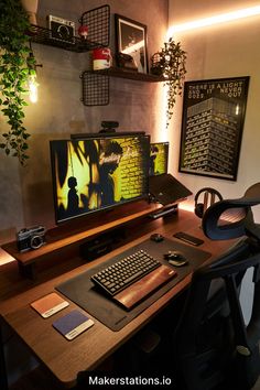 a computer desk with a keyboard, mouse and monitor on it in front of a plant