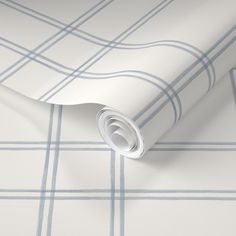 a white and blue wallpaper with checkered pattern on the outside, featuring a roll of tape