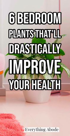 a bathroom with pink towels on the floor and a potted plant next to it