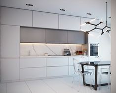 a modern kitchen with white cabinets and marble counter tops