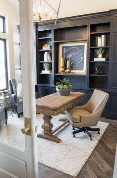 a chair and table in a room with built - in bookshelves