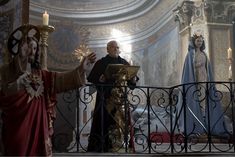 the priest is standing at the alter with two other priests