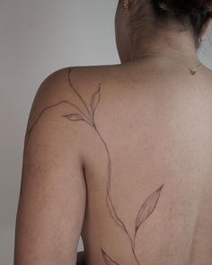 the back of a woman's body with leaves on it