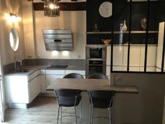 a kitchen with an island table and chairs