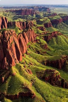 an aerial view of the green mountains and valleys in australia's outback region