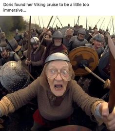 an old woman is surrounded by soldiers and holding spears in her hands as she looks surprised at the camera