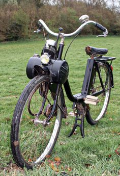 an old bicycle is parked in the grass