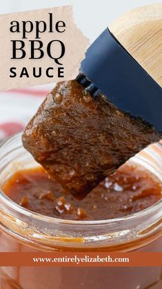 an apple bbq sauce in a jar with a wooden spoon sticking out of it