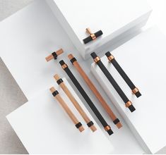 an assortment of black and copper objects on white paper