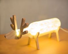 a small wooden deer is sitting on a table