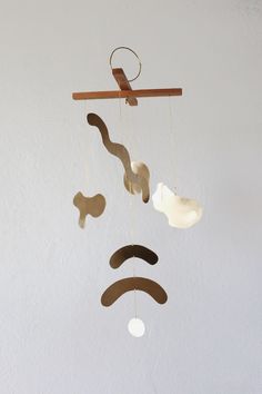 a mobile made to look like a man's face with mustaches hanging from it