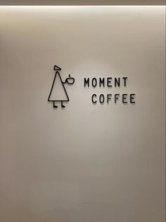 the moment coffee logo is displayed on the wall