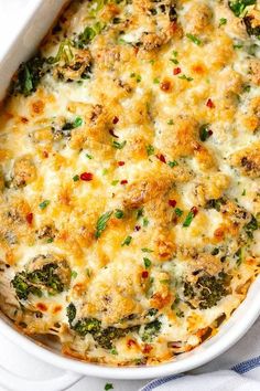 a casserole dish with broccoli, cheese and other toppings in it