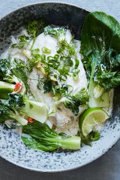 a bowl filled with rice and vegetables on top of a table