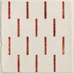 a white tile with red lines on it