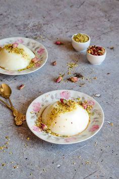 two plates with food on them and spoons next to one plate that has an egg in it