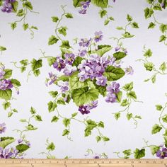 a white pillow with pink flowers and green leaves on the front, sitting against a white background