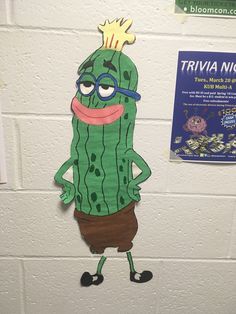 a paper cut out of a green cactus with a crown on it's head