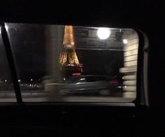 the eiffel tower is seen from inside a car window at night in paris, france