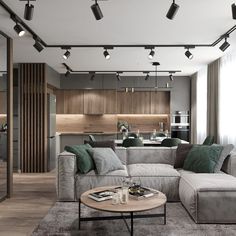 a living room filled with furniture and lots of lights hanging from the ceiling next to a kitchen