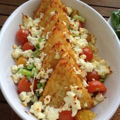 a white bowl filled with food on top of a wooden table