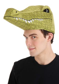 a young man wearing a green alligator hat