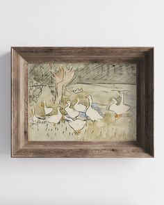 a painting hanging on the wall next to a wooden frame with ducks swimming in it