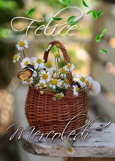 a basket filled with daisies sitting on top of a wooden table