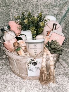 a basket filled with lots of different items on top of a couch next to a potted plant