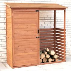 a wooden storage shed with logs in it