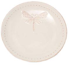 a white plate with a dragonfly on it