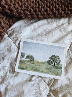 an old photo is laying on top of a blanket