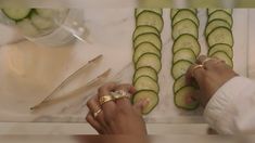 a person is cutting cucumbers on a table