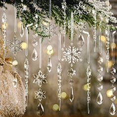 a christmas decoration hanging from a tree with snowflakes and ornaments attached to it