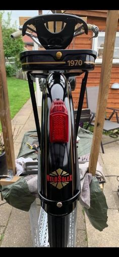 a close up of the tail light on a bike parked in front of a house